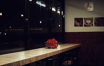 Cozy Cafe Interior with Red Roses on Wooden Counter