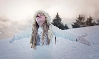 Happy Girl in Snow with Fur Hat and Mittens