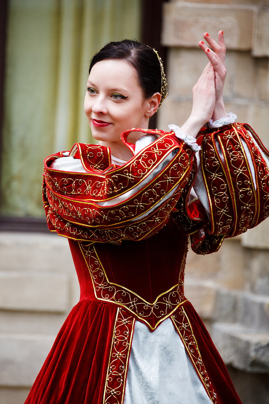 Woman in Red Medieval Costume Dancing Outdoors