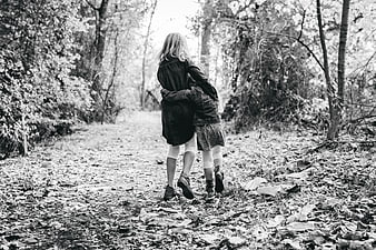 Two Girls Walking Away on Forest Path in Black and White