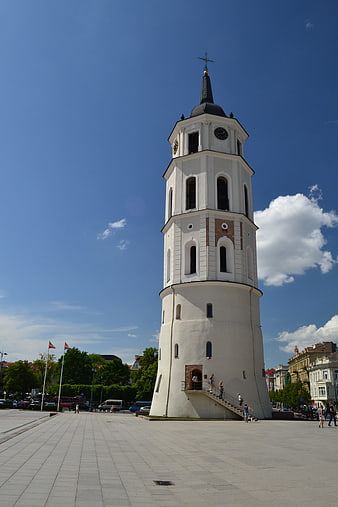 White Church Tower in Town Square Under Blue Sky