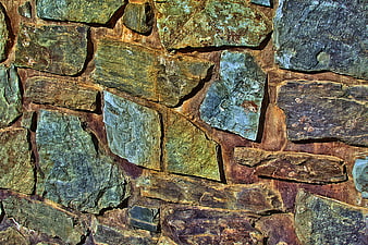 Textured Natural Stone Wall with Green and Brown Tones