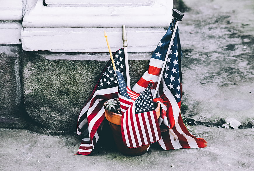 American flags in a pot at a memorial site