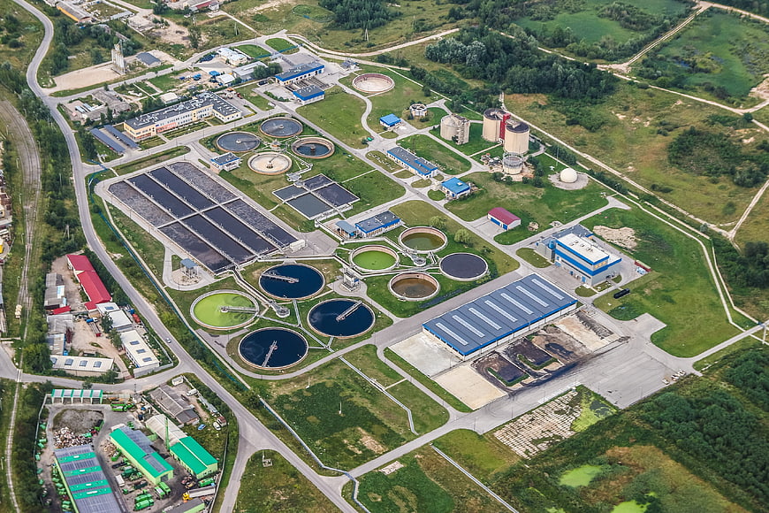 Aerial view of modern wastewater treatment plant with circular tanks