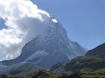 Matterhorn mountain peak with clouds and alpine landscape