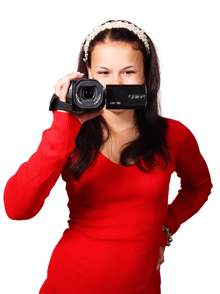 Woman in Red Dress Holding Black Video Camera