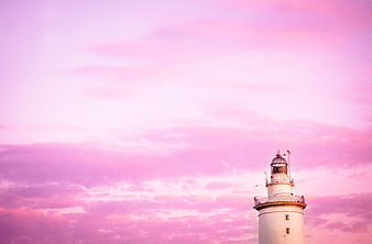 White Lighthouse Against Pink Sunset Sky