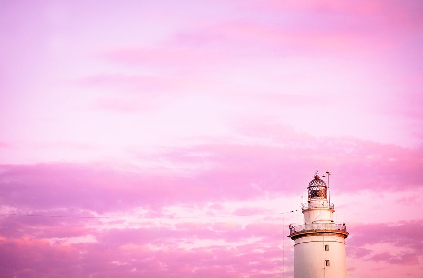 White Lighthouse Against Pink Sunset Sky