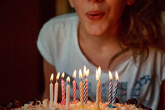 Girl Blowing Out Birthday Cake Candles Close Up