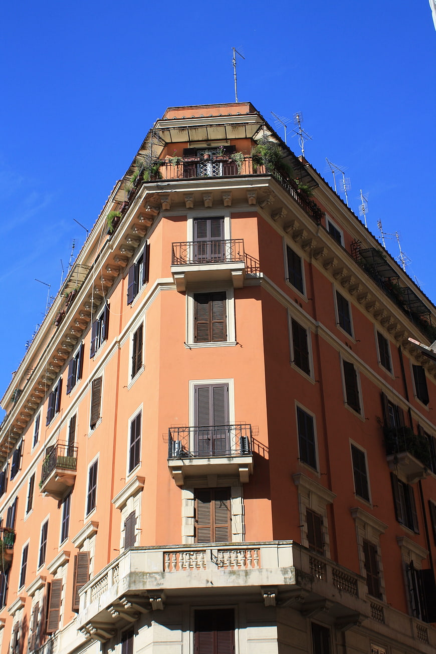 Low angle view of orange Italian building facade against blue sky