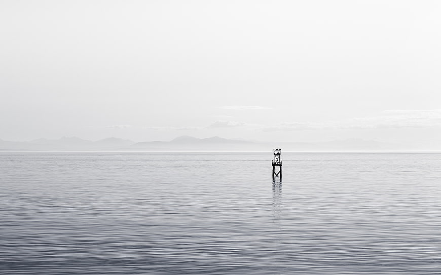 Minimalist Black and White Ocean Landscape with Solitary Tower