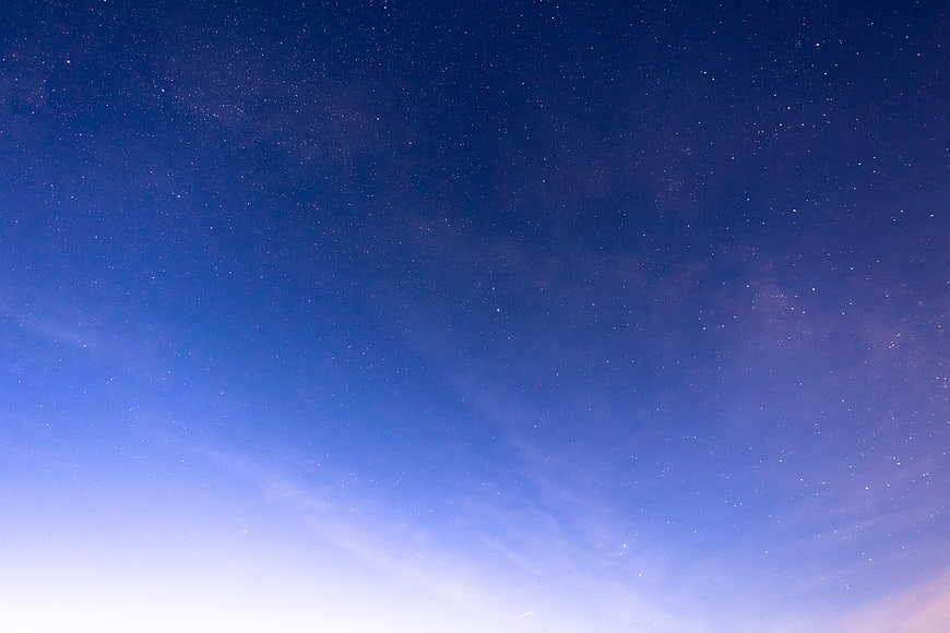 Starry Night Sky with Milky Way and Gradient Blue Background