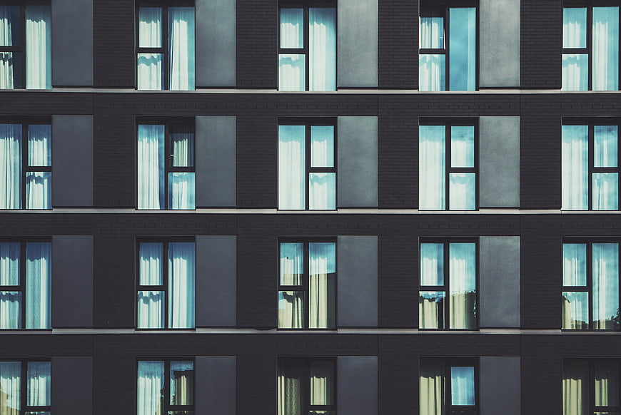 Modern Apartment Building Facade with Blue Windows