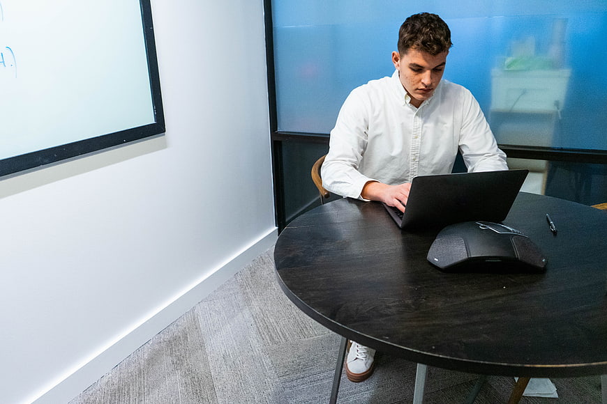 Young man working on laptop in modern office