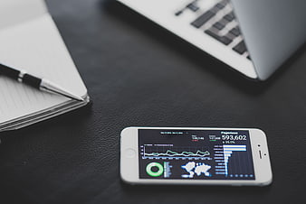 Smartphone displaying analytics dashboard on office desk