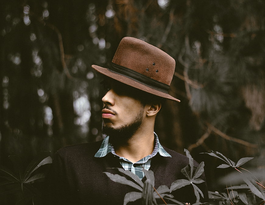 Man in Fedora Hat Looking Away in Forest