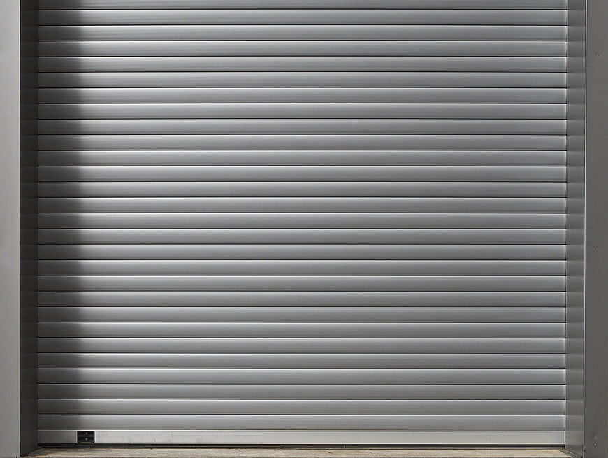 Closed Gray Metal Roller Shutter Door Texture Background