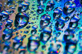 Abstract macro water droplets with iridescent rainbow reflections