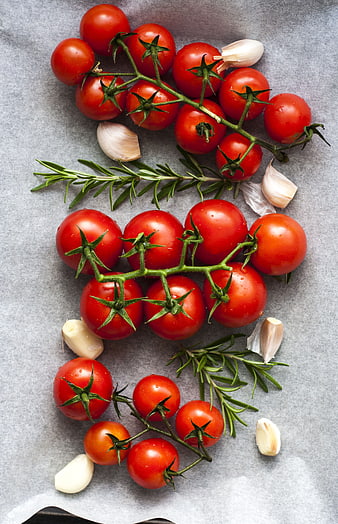 Fresh Cherry Tomatoes, Garlic, and Rosemary Flat Lay on Gray Background