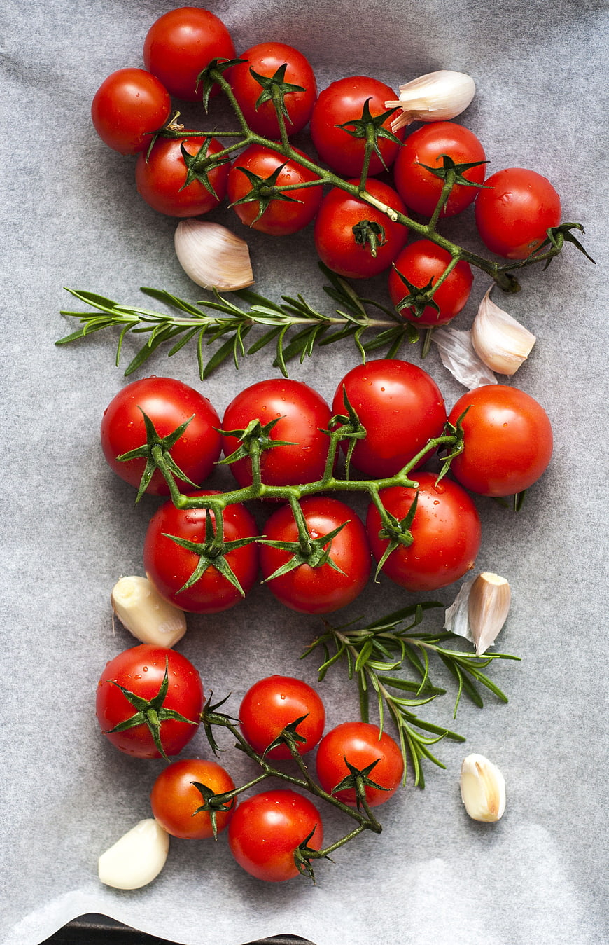 Fresh Cherry Tomatoes, Garlic, and Rosemary Flat Lay on Gray Background
