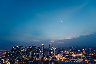 Moscow City Skyline at Dusk with Moon and Water Reflections