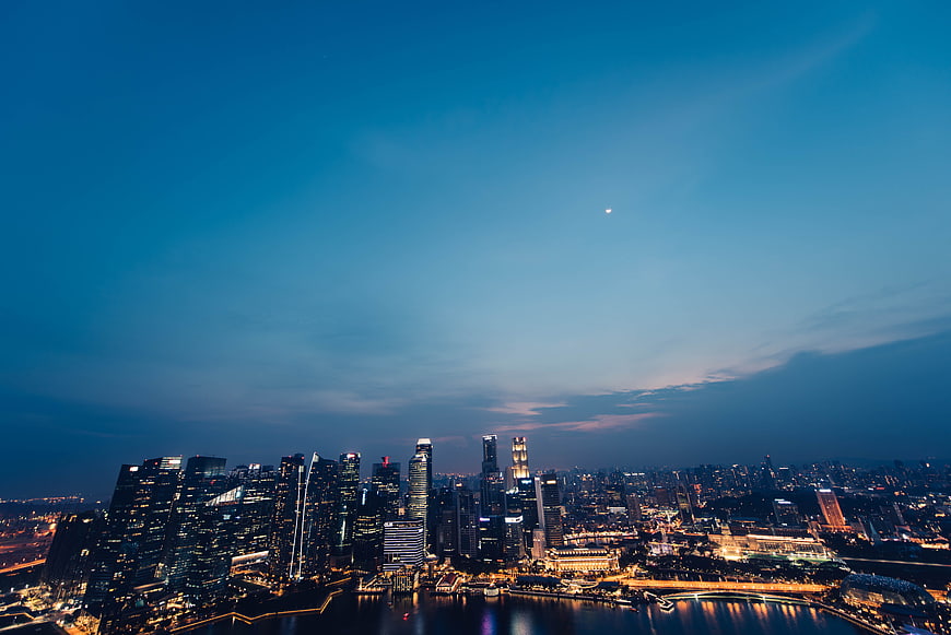 Moscow City Skyline at Dusk with Moon and Water Reflections