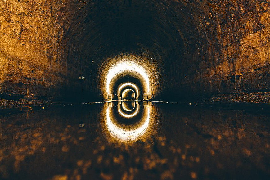 Symmetrical Underground Tunnel with Water Reflection