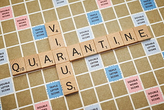Quarantine spelled with Scrabble tiles on game board