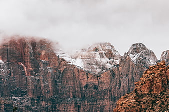 Snowy Red Rock Mountains Shrouded in Mist