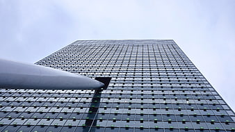 Low angle view of modern skyscraper with grid facade