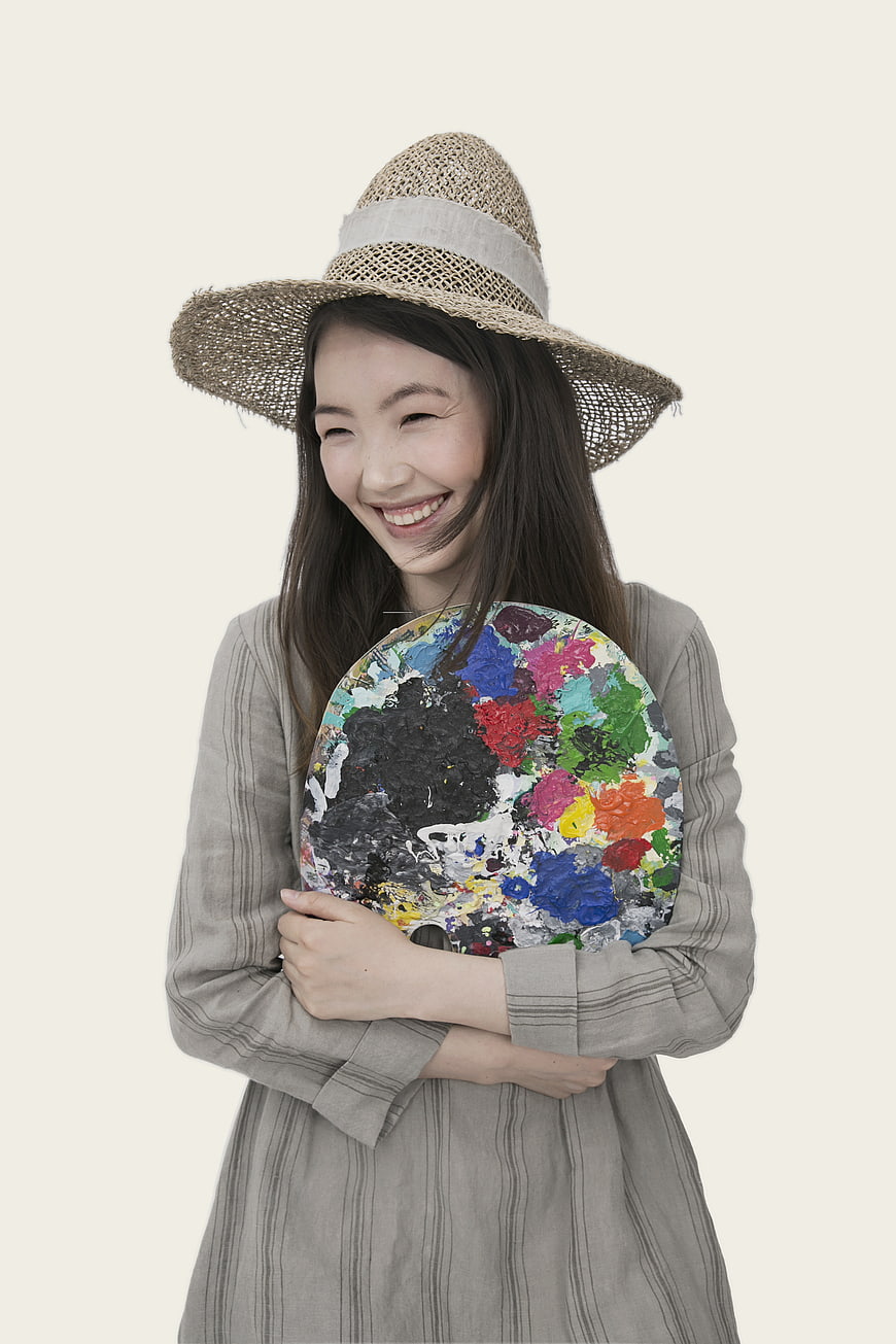 Happy Asian Woman Holding Paint Palette in Studio