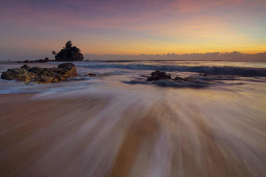 Long Exposure Sunset Ocean Waves on Rocky Beach