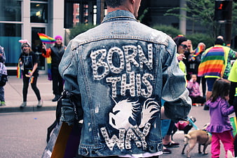 Man with studded denim jacket at pride parade