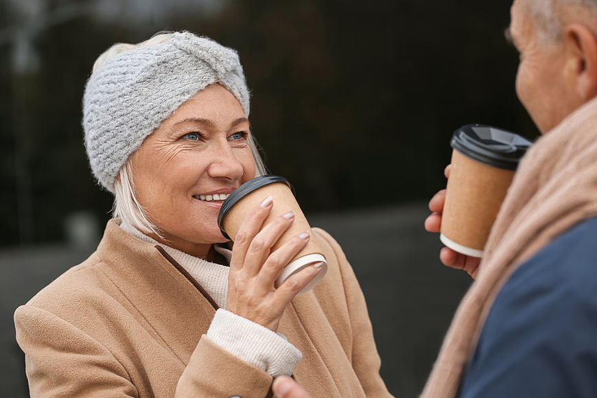 Happy Senior Couple Drinking Coffee Outdoors