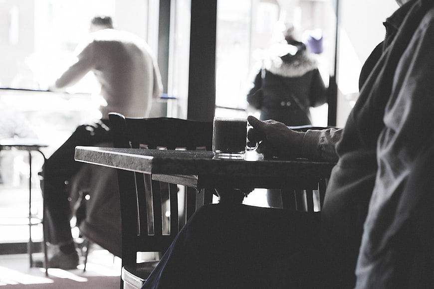 Black and white cafe scene with coffee cup on table