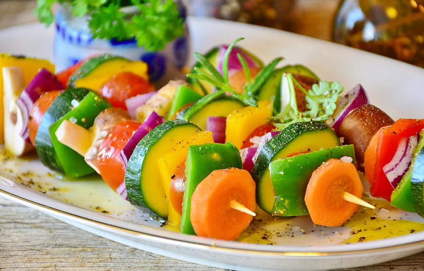 Colorful Raw Vegetable Skewers on White Plate