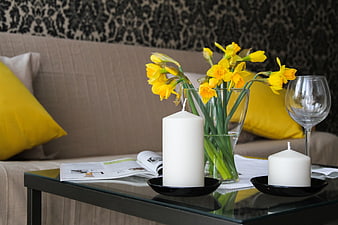 Yellow Daffodils and White Candles on Glass Coffee Table in Living Room