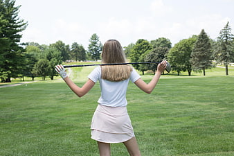 Woman Golfer Holding Club on Green Course