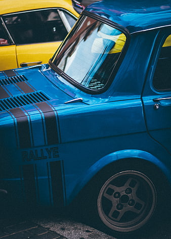 Close-up of Blue Vintage Rallye Car with Yellow Classic Car