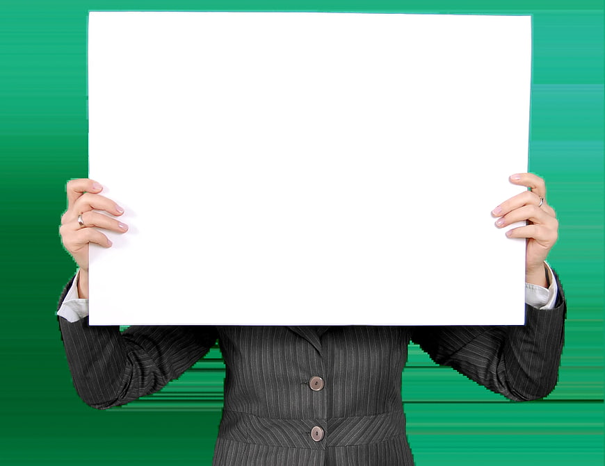 Businesswoman holding blank white sign against green background