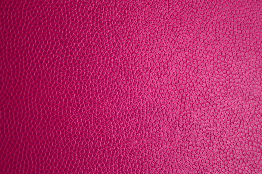 Close-up of vibrant pink textured leather surface