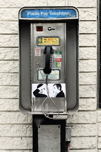 Vintage Public Pay Telephone on Textured Wall