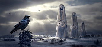 Surreal winter landscape with crow and mysterious hooded stone statues