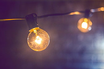 Glowing Vintage String Light Bulb with Bokeh Background