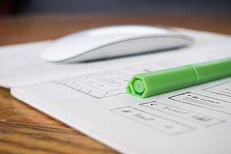 Green Pen on UX Wireframe Sketch with Mouse