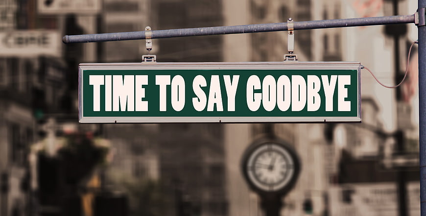 Green street sign reading time to say goodbye