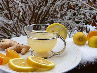 Hot Lemon Ginger Tea on Snowy Winter Background