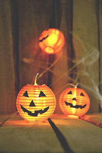 Glowing Halloween Pumpkin Lanterns on Wooden Floor