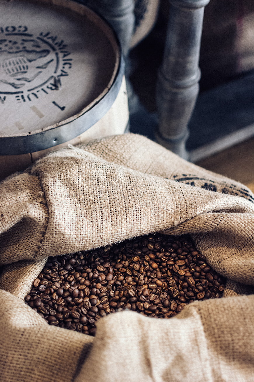 Roasted coffee beans in open burlap sack