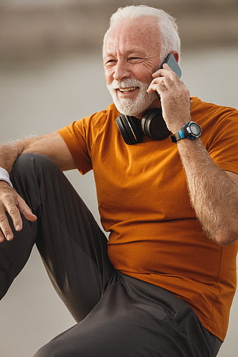 Happy Senior Man Talking on Smartphone with Headphones